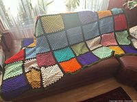 Blanket draped on sofa showing full size and colour layout