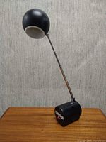 Lamp fully extended upright on wood surface