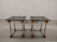 Front view of both matching chrome, wood and smoked glass end tables