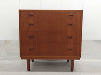 front view showing three drawers and recessed pulls