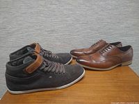 Both pairs of shoes side by side on table
