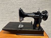 Left front view showing overall machine and fold-out bed