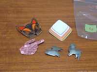 All six brooches laid out on table