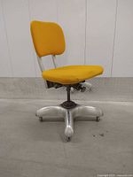 Front view showing yellow seat/back and aluminum base