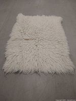 Full top view of cream shag Flokati mat