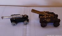 Two toy cannons side by side showing overall form and scale