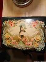 Front cover showing chromolithograph maiden, roses, and gilt design under celluloid