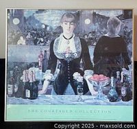 Front view of framed poster showing artwork, frame, and glass