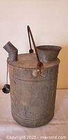 Full view of galvanized fuel can, spout, funnel, handle visible