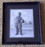 Full view of framed black-and-white print showing child football player
