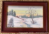 Front view of framed winter landscape painting