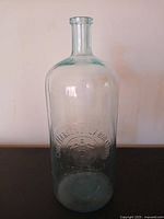 Full front view of embossed Chr. Hansen's Laboratory bottle