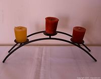 Front view showing entire candle holder with three candles