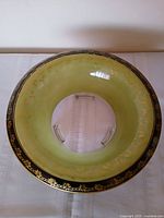 Top view showing green body, black rim, gilt decoration