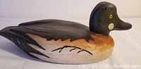 left side view of painted wooden duck decoy