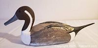 Side view of painted wooden Northern Pintail decoy