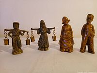All four brass/bronze child figurines front view