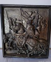 Front view of plaque showing full relief scene of knights, frame visible