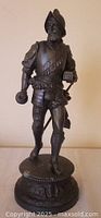 Front view of metal Renaissance soldier figurine on round base