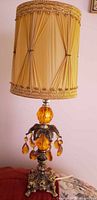 Full view of lamp showing base, glass orb, prisms and shade
