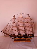 Full view of three-masted Pride of Baltimore II model on base