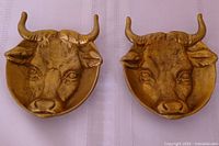 front view showing bull head relief on both brass dishes