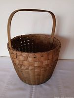 full view of round woven basket with handle