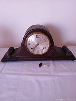 Front view of Sessions tambour mantel clock with key