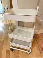 full view of 3-tier white rolling cart showing casters and handles