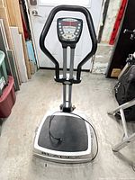 Full view of Bladez Fitness ActivePower vibration plate machine showing handlebar, console, platform, and power cord