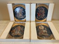 Four boxed collector plates packed in original foam and plastic
