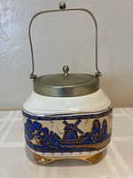 Front view of Regent porcelain biscuit jar showing decoration, lid, and handle