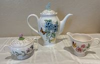 Coffee pot, sugar bowl with lid, creamer front view