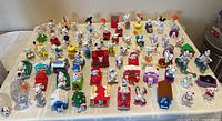Full table view of approx. 80 Dalmatian Happy Meal toys