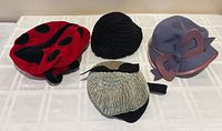All four hats grouped on table