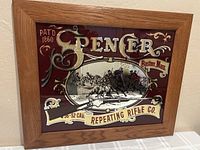 Front view showing entire framed Spencer advertising mirror