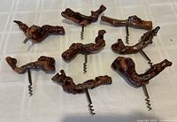Eight burlwood corkscrews arranged on table