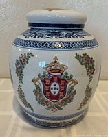 Front view of porcelain ginger jar showing crest and florals