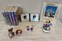 Overall lot: five VHS tapes, two Fantasia CDs, Disney book, ceramic figures, PVC figures, Minnie music box