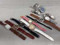 Group shot of all 11 wristwatches showing variety of straps, cases and dial colours