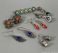 Group shot of all five earring pairs and brooch