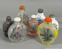 Group image of all seven snuff bottles displaying variety of materials and painted scenes