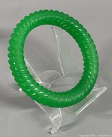 Jade bangle on stand showing rope twist detail
