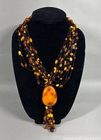 Necklace on display bust showing full multi-strand design and pendant