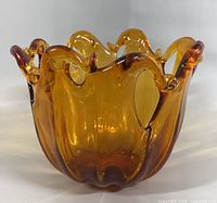 Front view of amber Murano glass bowl showing free-form rim and color