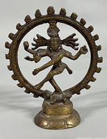Front view of brass Shiva Nataraja statue showing details of deity and flame ring