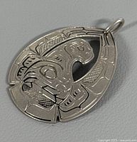 Front view of engraved Haida silver pendant