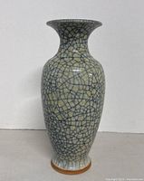 Full front view of tall crackle-glaze ceramic vase