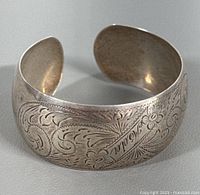 Full view of engraved sterling silver cuff