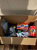 Top view of box showing Tide boxes, KD Cloth package, various bottles